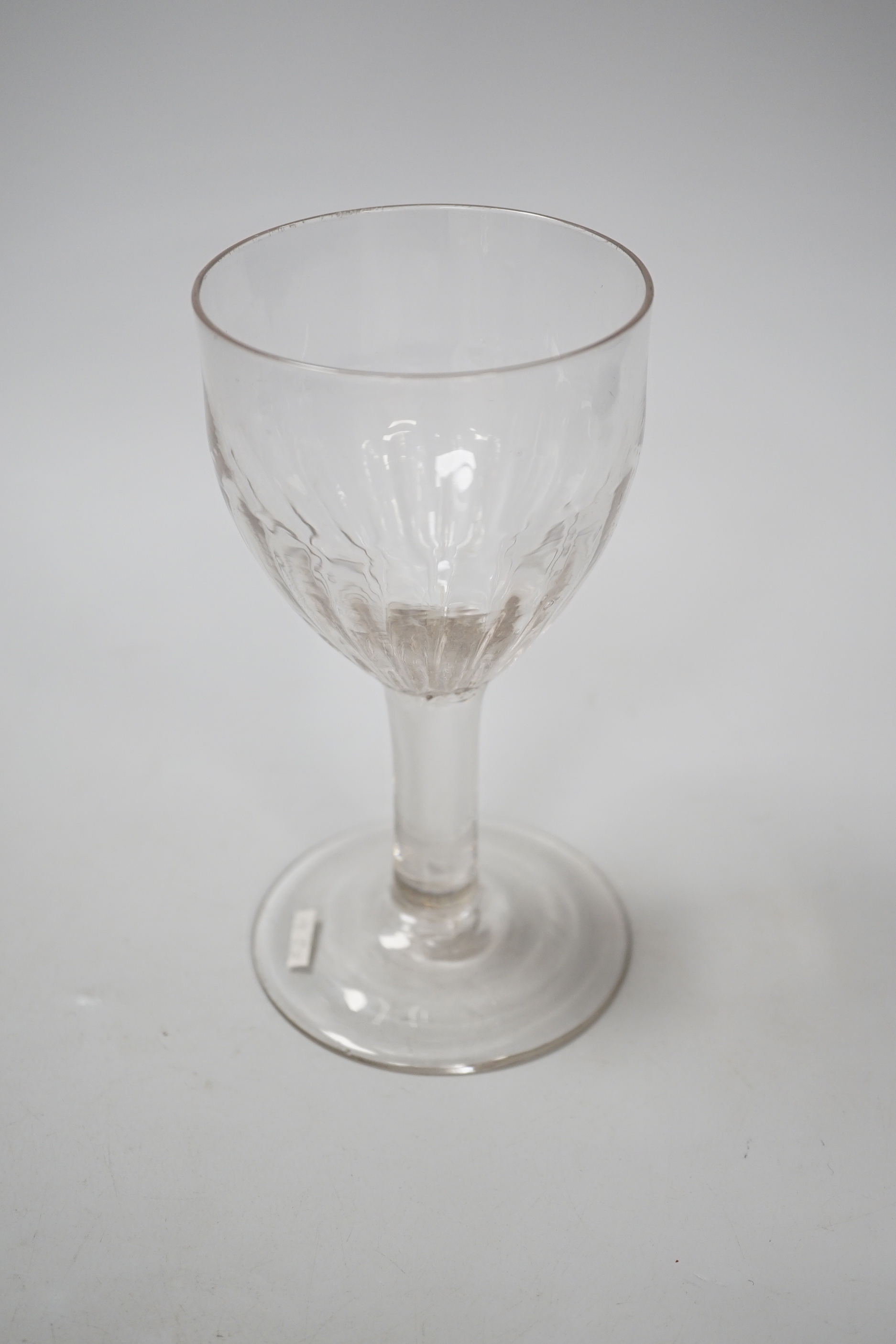 An English lead crystal flute moulded goblet, c,1740-50, a rare form with the lower half of the rounded ovoid bowl moulded with flutes on a plain stem and plain foot, 16.7cm high